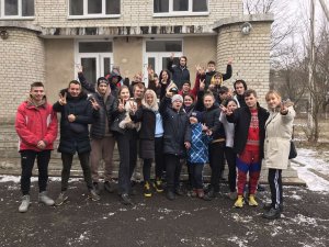 Teacher and students in front of vocational school in Kharkyv