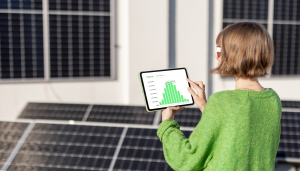 a woman holding a tablet surrounded by solar panels