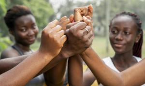 young African girls joining their fists