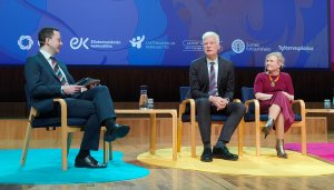 On stage, with a screen in the background, ETF Director, Pilvi Torsti (dressed in magenta), is sitting next to the OECD's Andreas Schleicher and a moderator