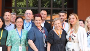 Photo depicting group of twenty professionals gathered in a group outside