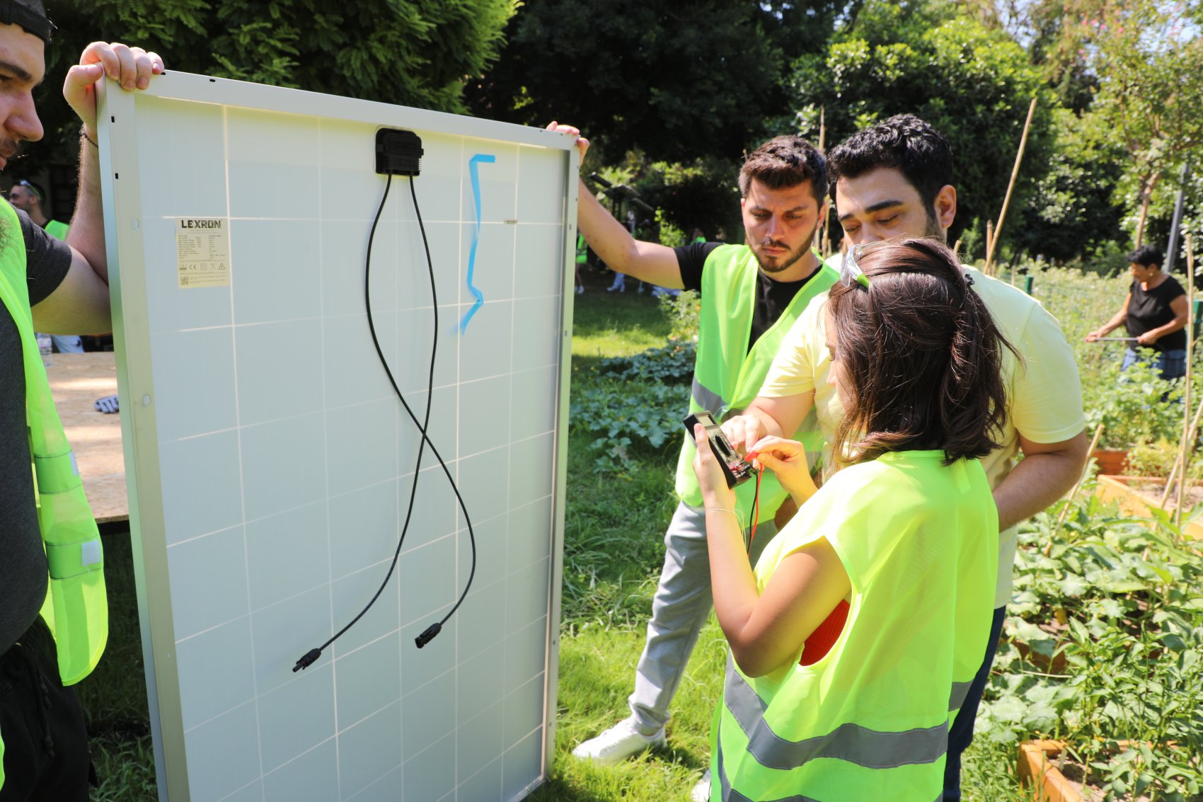 A teacher explaining to a group of students how a solar panel works