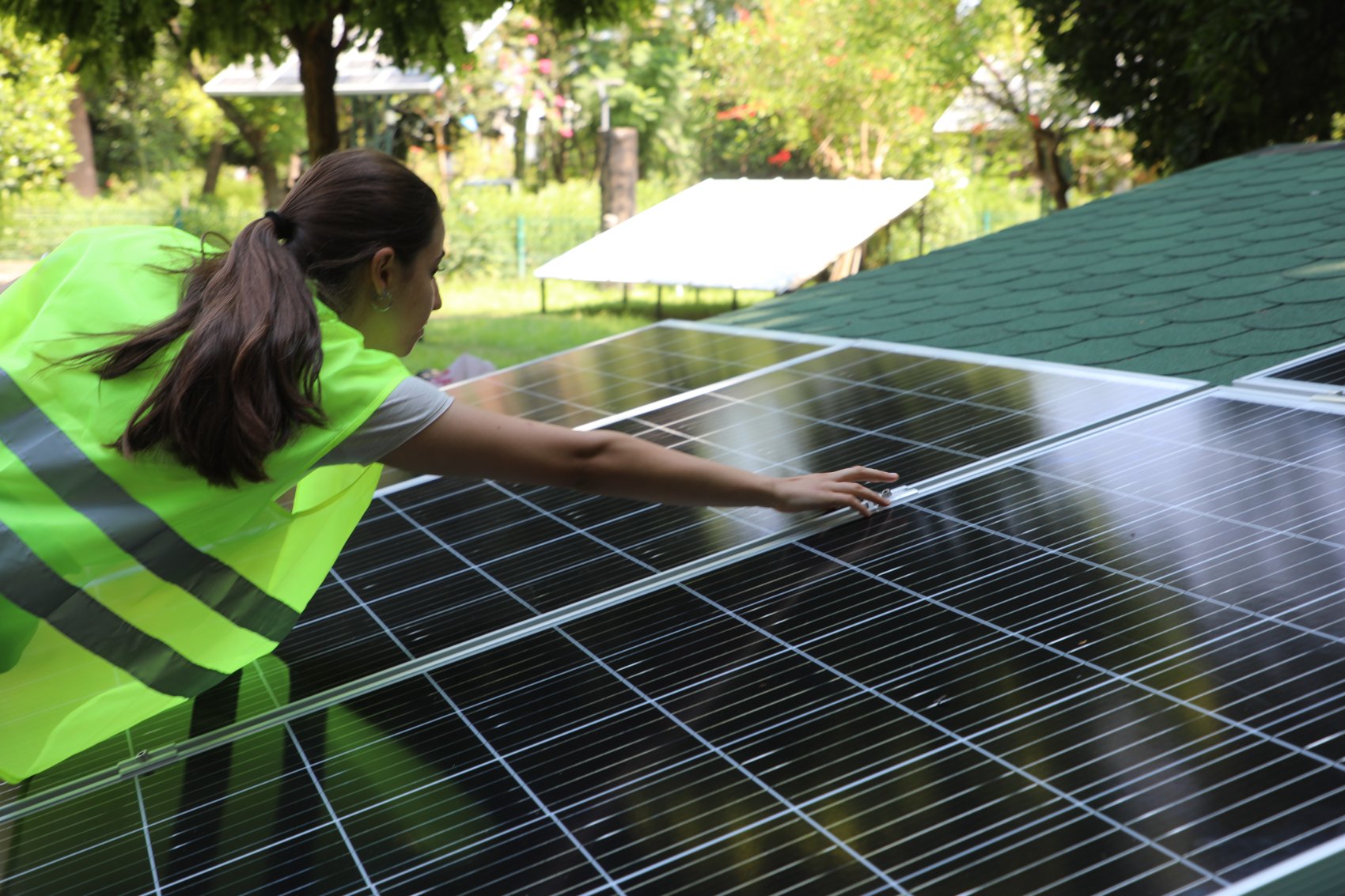 A female student working on a solar panel as part of a solar energy training programme