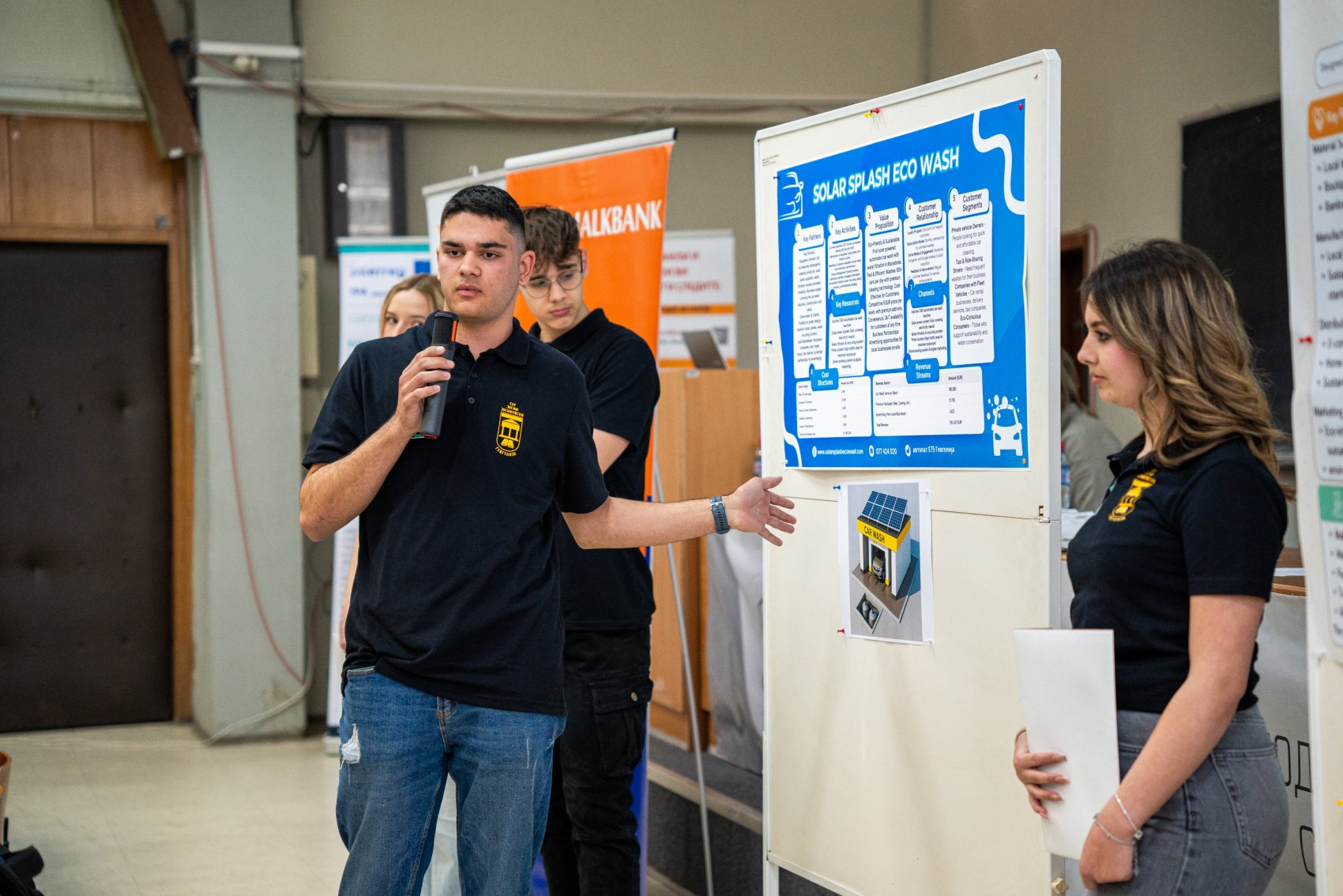 Students presenting their eco-friendly business ideas at a sustainable innovation competition