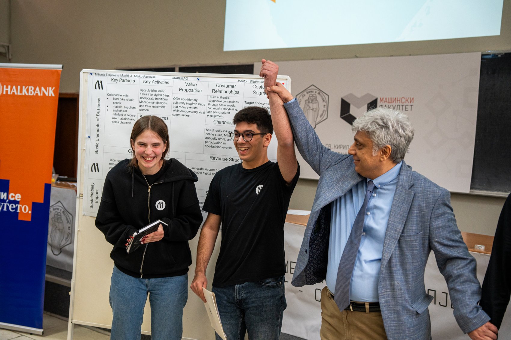 Students celebrating a successful pitch of a green business idea at a sustainable innovation competition