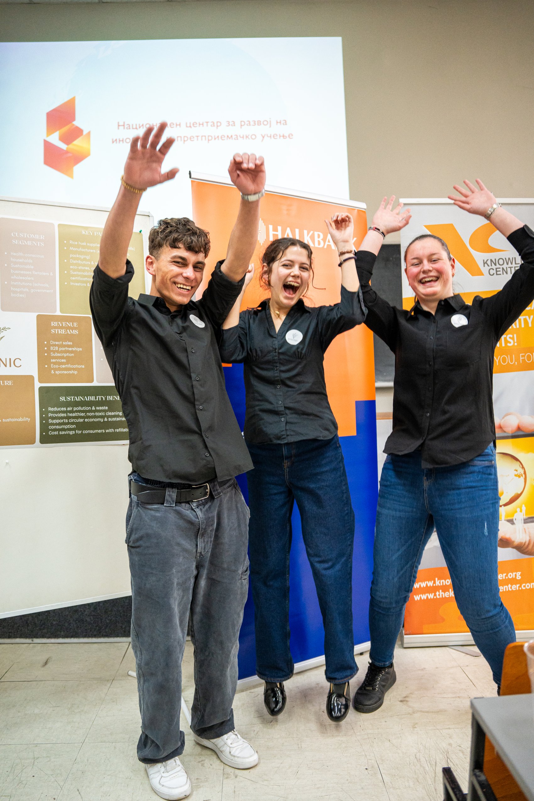 Students celebrating their winning entry at a competition to find innovative eco-friendly business ideas