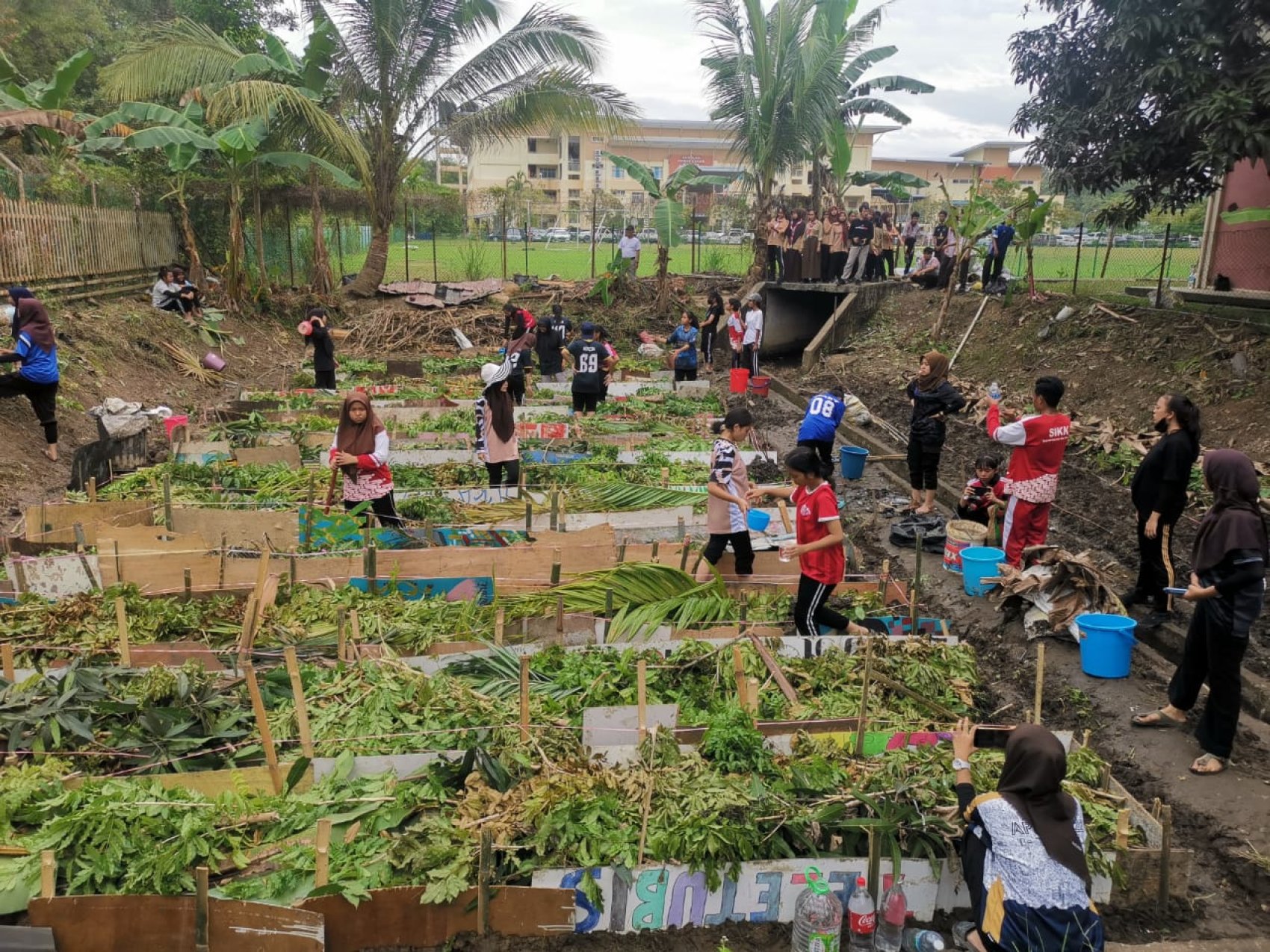 Students working in the school gardens in Malaysia to produce eco-friendly compost from their innovative food waste programme