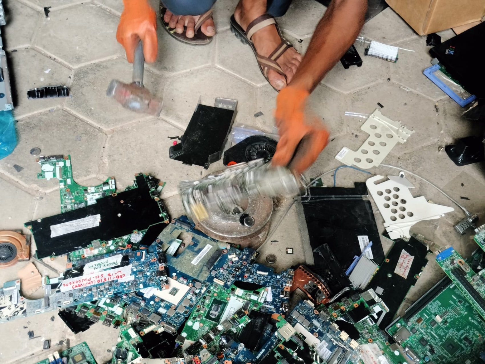 Worker recycling e-waste including circuit boards