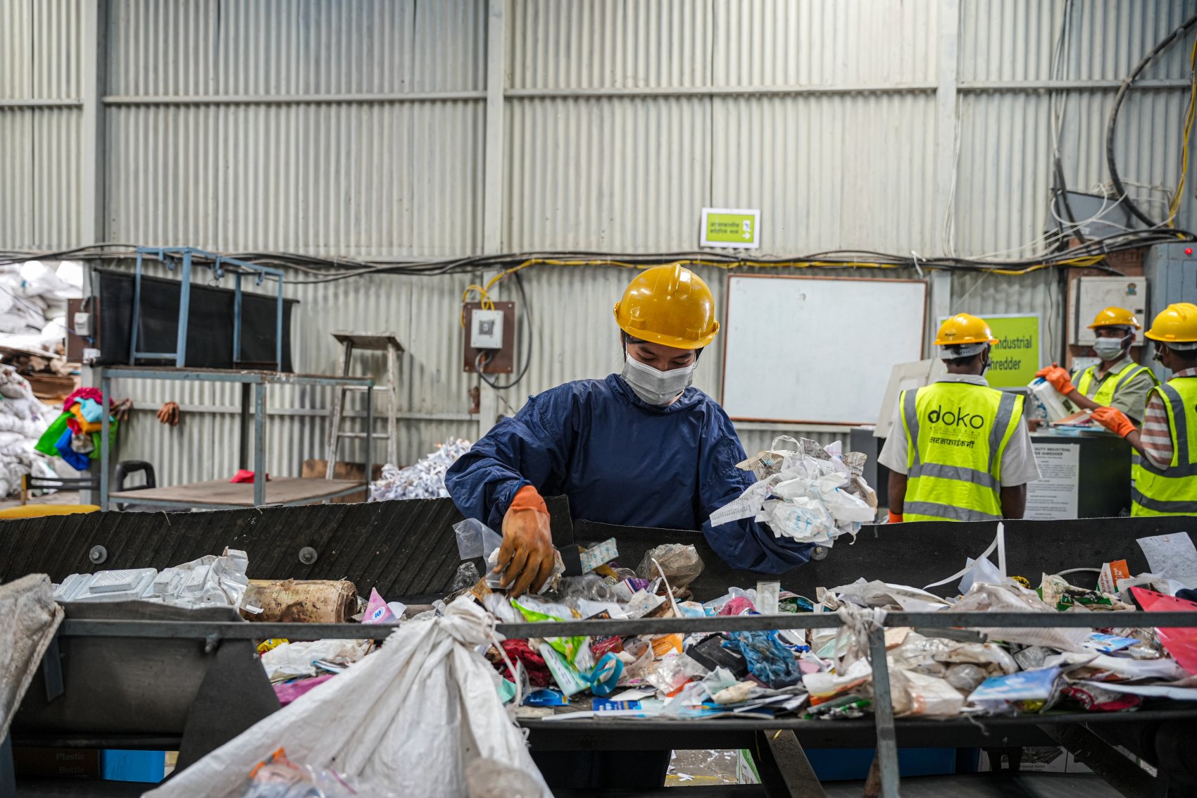 Worker in a e-waste recycling plant