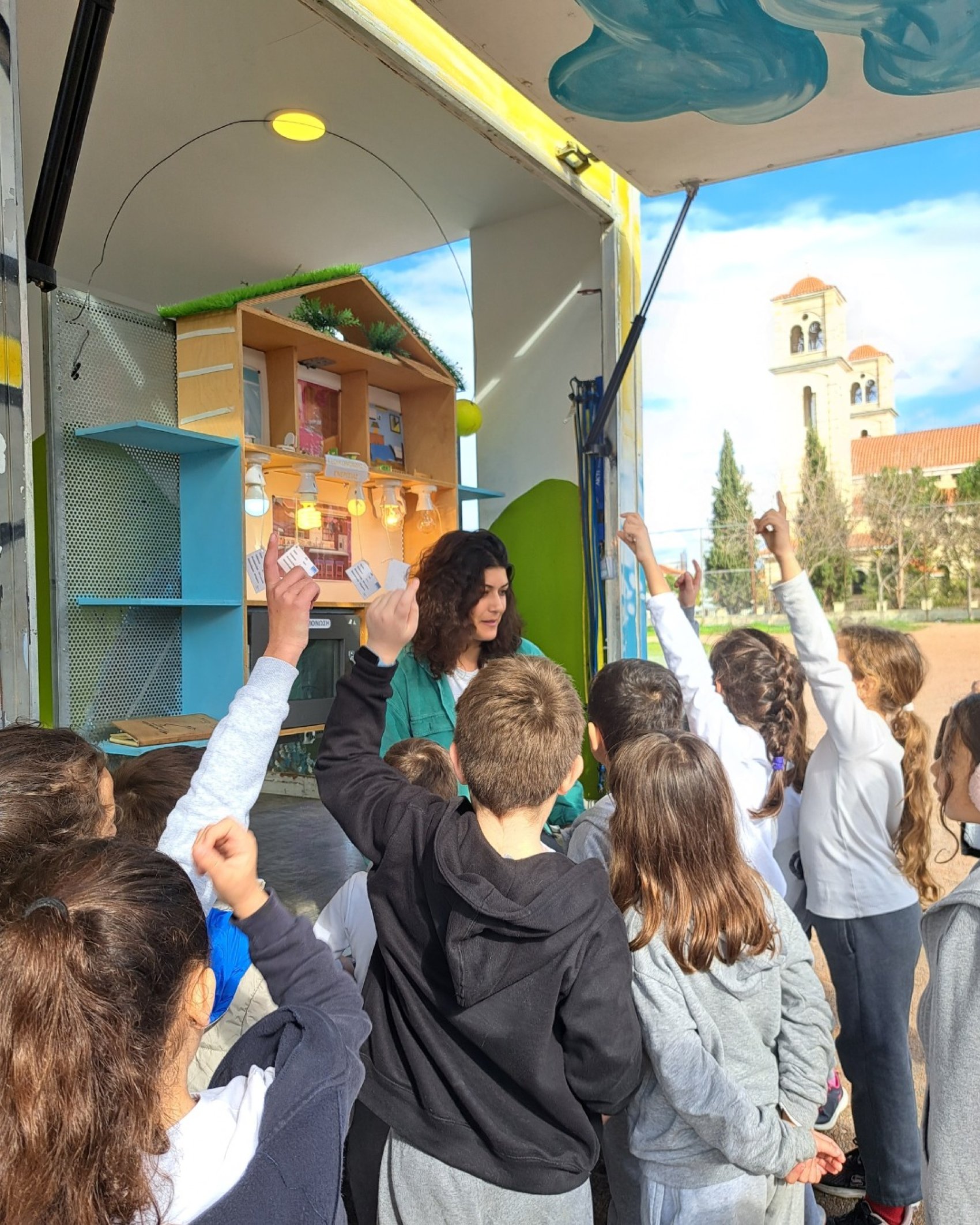 A female teacher with children at the mobile environmental education unit