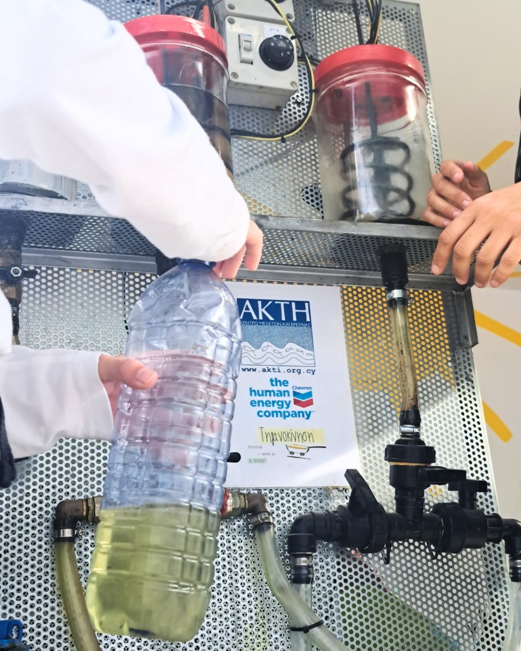A young learner measuring oil in the mobile educational unit