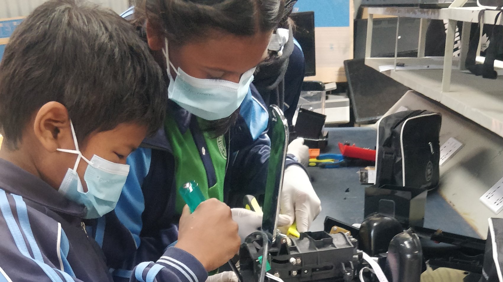 Children gaining hands-on experience of repairing e-waste