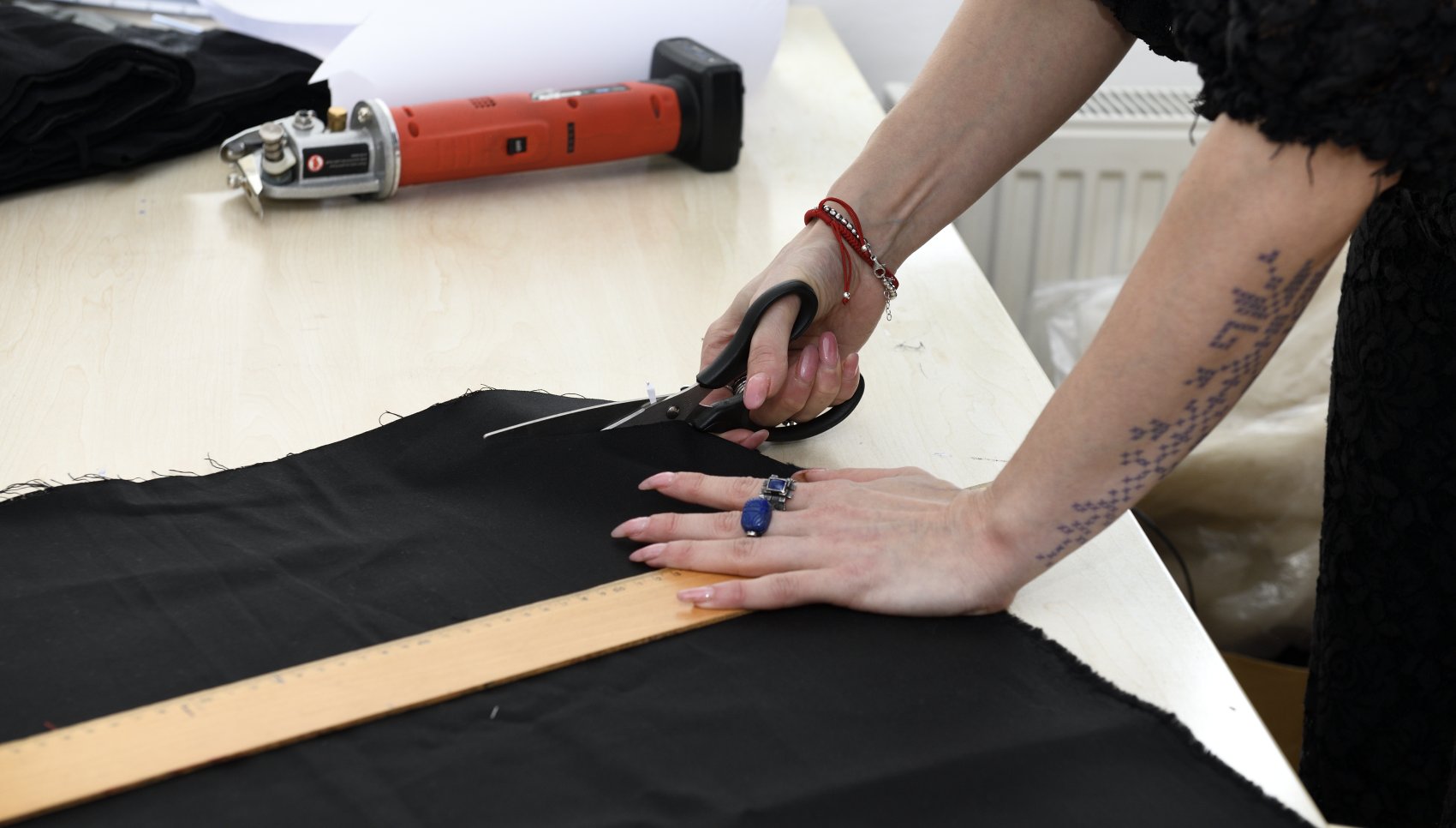 Designer cutting fabric with scissors