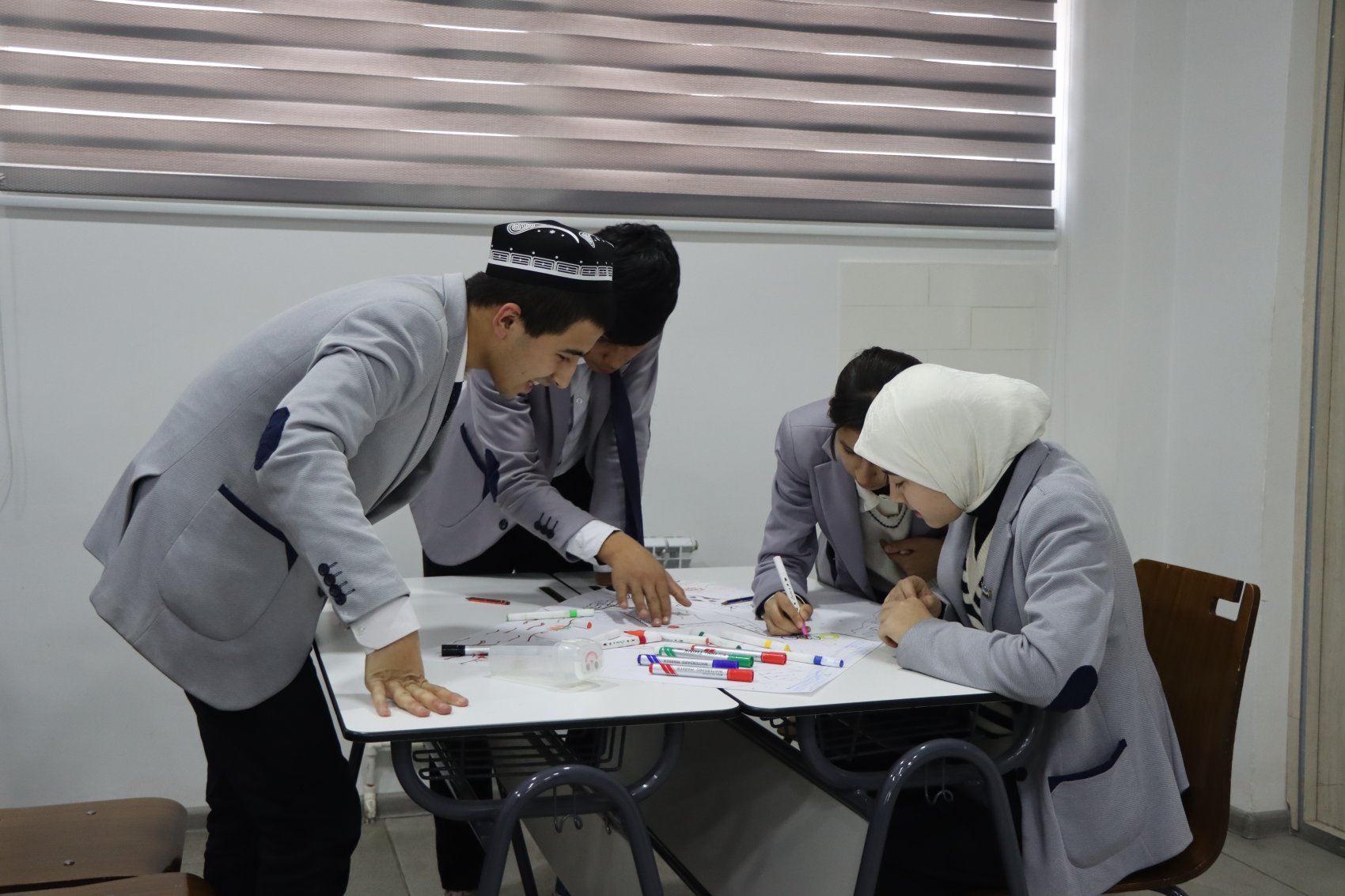 School children working around a desk