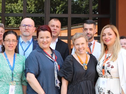 Photo depicting group of twenty professionals gathered in a group outside