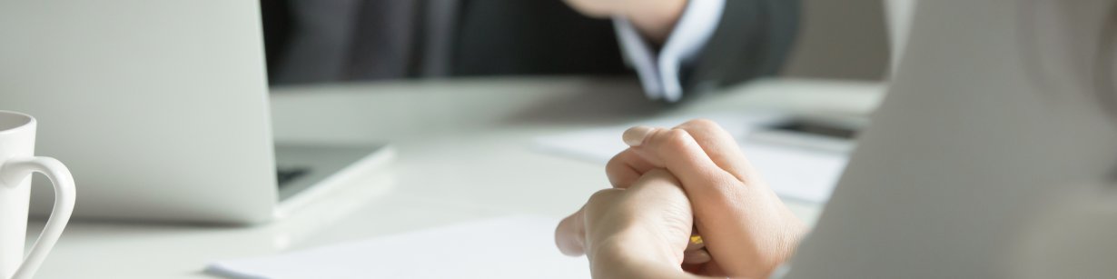 man with laptop - woman with paper