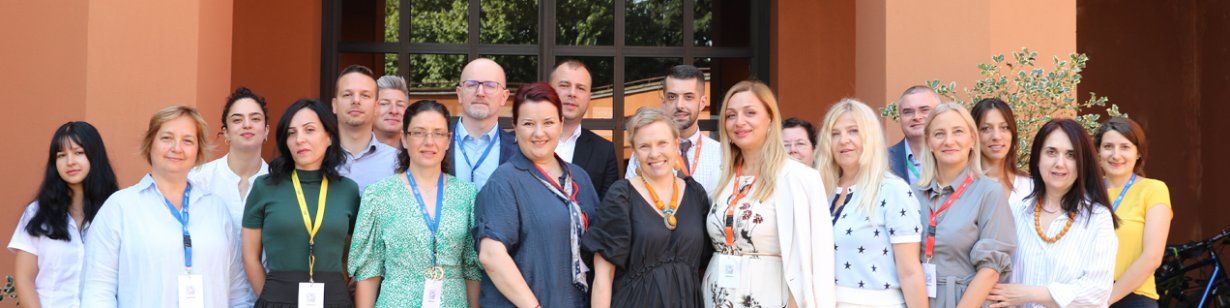 Photo depicting group of twenty professionals gathered in a group outside